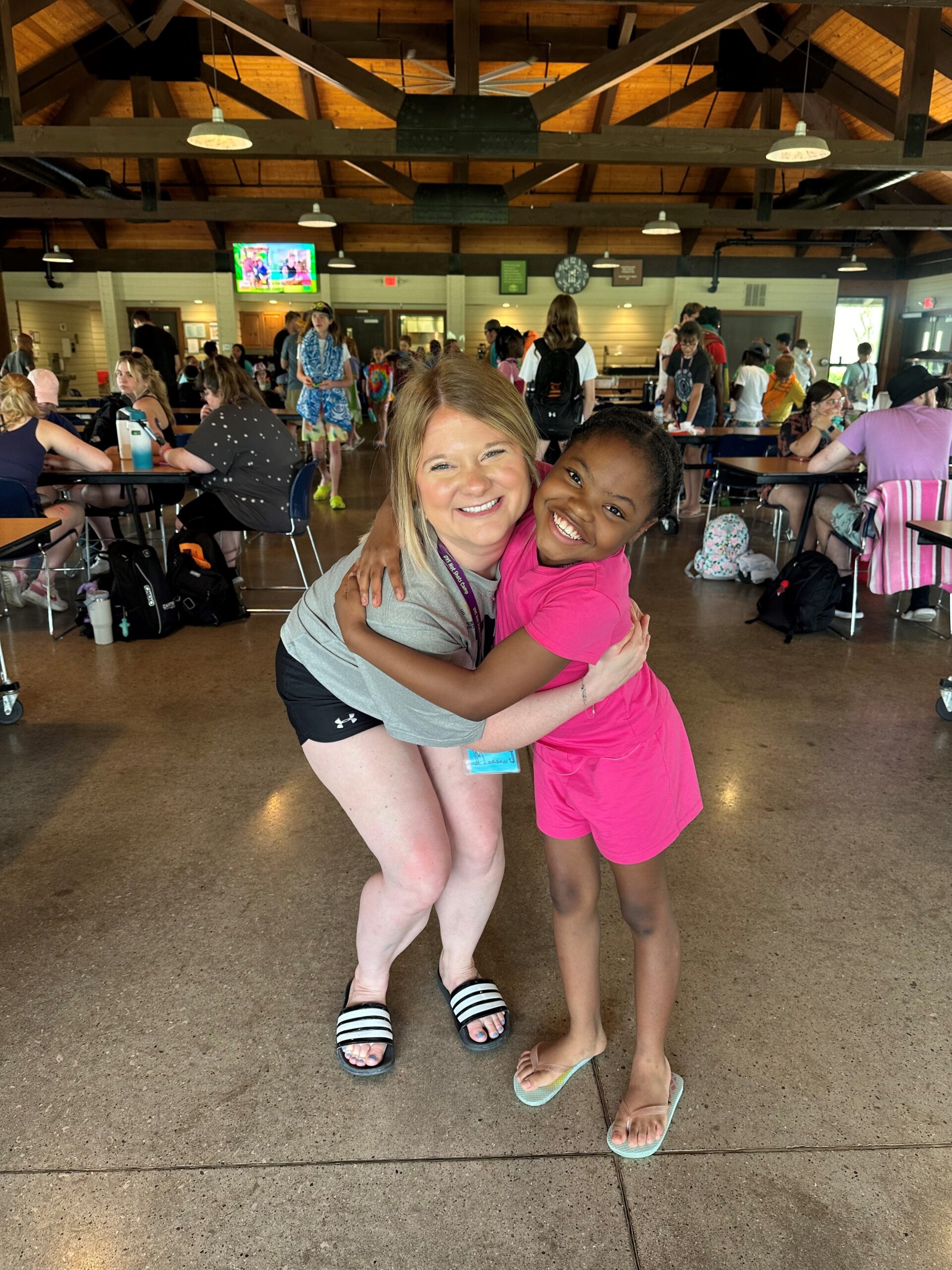 Morgan Johnson hugs a camper during Little Shots Camp, where children living with Type 1 diabetes build confidence and friendships.