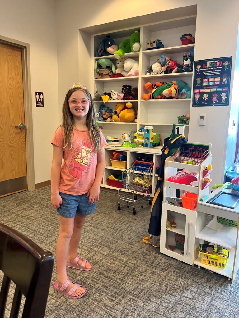 Child smiles in the playroom at Ronald McDonald House Northwest Ohio during his family's stay.