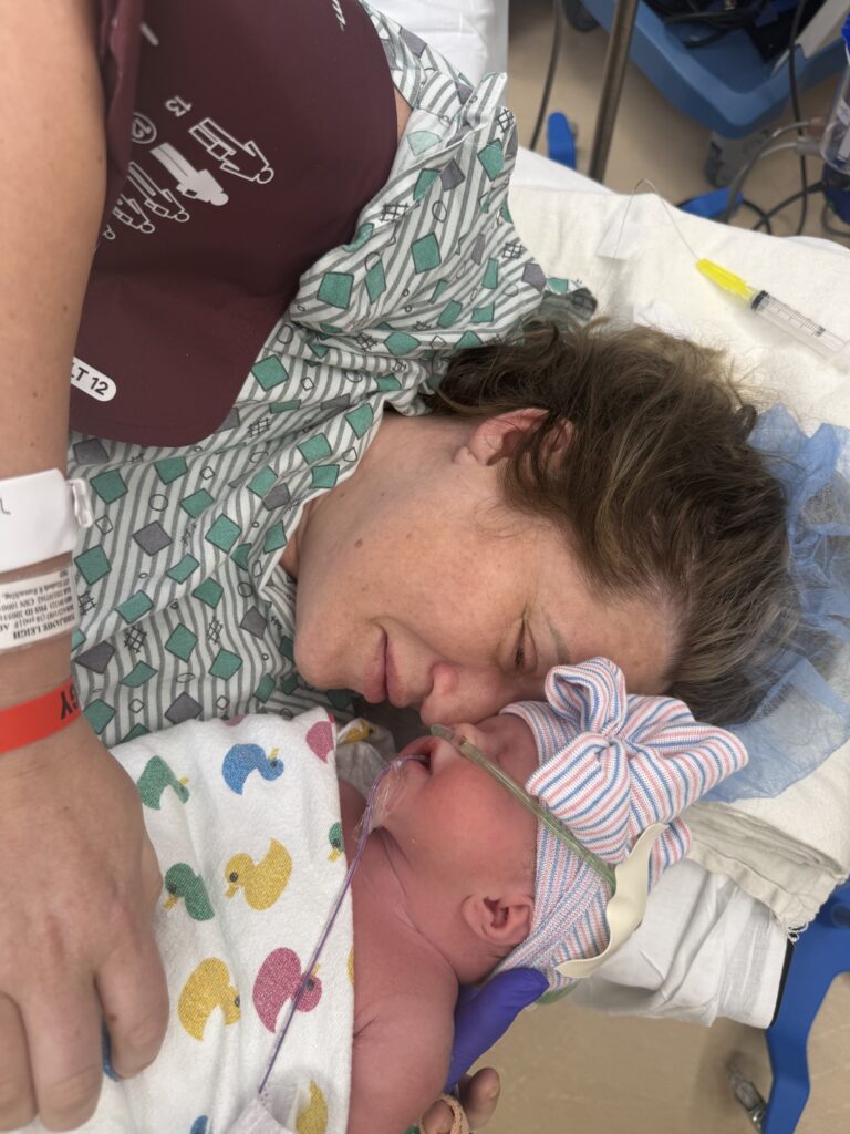 Jamie McMillan beside newborn Joslyn shortly after delivery