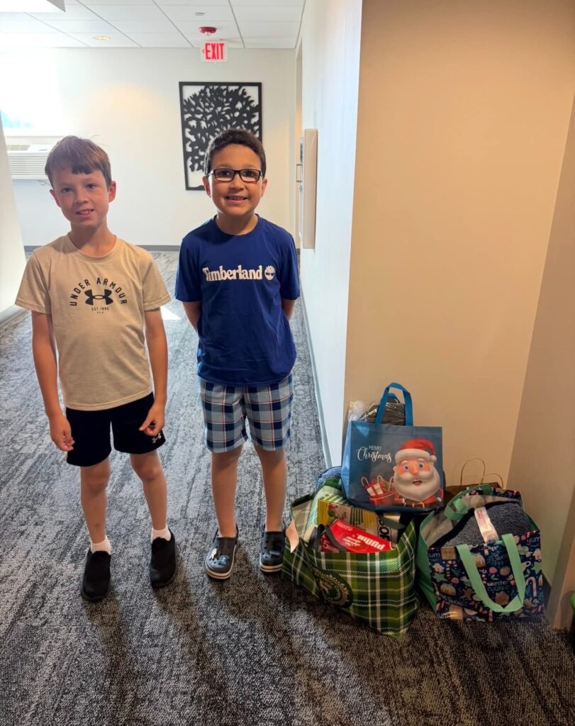 Carter and Colton Stephens with Christmas in July gifts at Ronald McDonald House Northwest Ohio